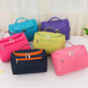 A collection of colorful, large waterproof hanging makeup bags in shades of blue, purple, pink, and lime green.