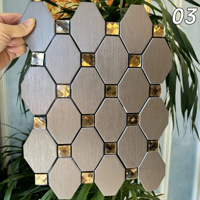 A hand holds a hexagonal mosaic tile pattern featuring silver and gold accents against a green plant background.