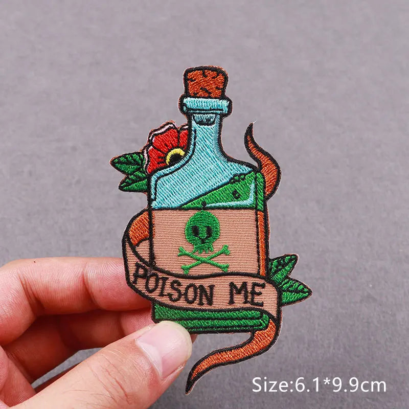 An embroidered patch depicting a green bottle with a red flower and a label that reads Poison Me