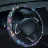 A close-up of a black steering wheel covered in sparkling crystal rhinestones.