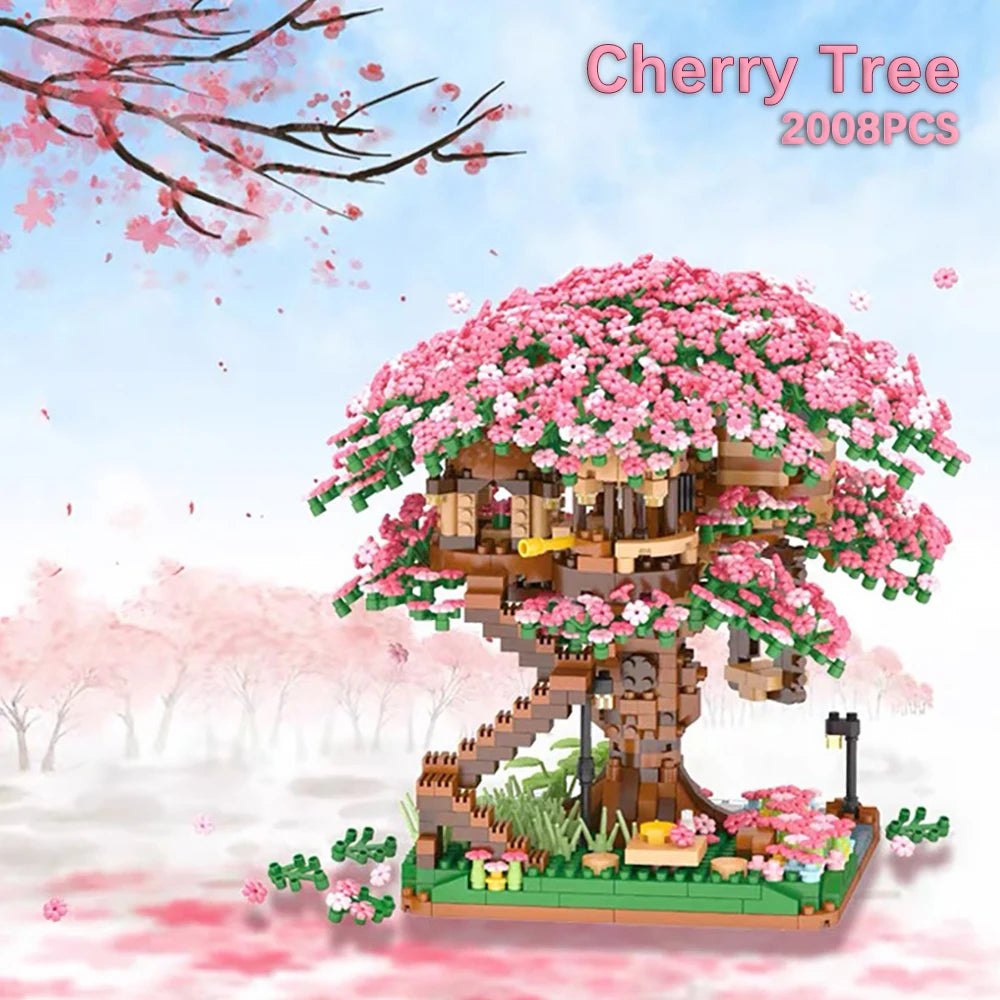 A pink cherry tree house model built from LEGO bricks with pink blossoms and a small landscape.