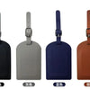 Four luggage tags in black, gray, blue, and brown leather with metal attachments.