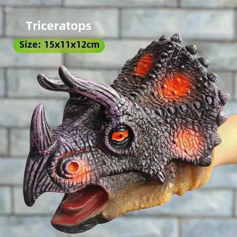 A realistic Triceratops dinosaur head puppet made of silicone, featuring textured scales and orange eyes.