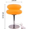 Orange cloud-shaped bedside lamp with a silver stand and remote control.