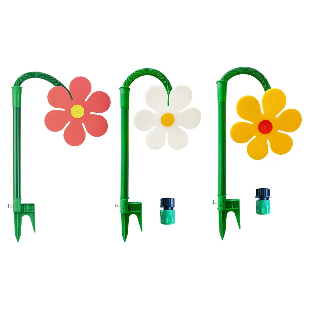Un jeu de trois arroseurs de pelouse floraux verts et rotatifs avec des têtes de fleurs rouges, blanches et jaunes.