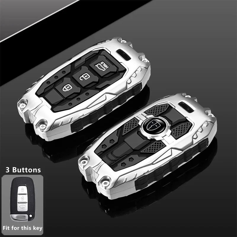 Silver protective key fob cover with three buttons shown against a dark background.