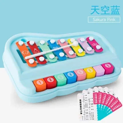 A light blue Montessori musical xylophone piano with pink and yellow colored bars for toddlers.