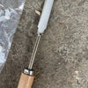 A carbon steel manual weeding tool set featuring a sickle, weeder, and hand shovel resting on a gray stone surface.
