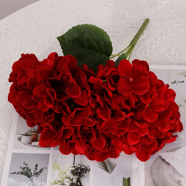 A bouquet of five silk hydrangeas in vibrant red flowers