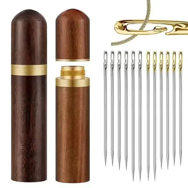 A set of twelve self-threading sewing needles with a wooden storage case and gold-colored clip.