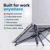 A silver magnetic phone holder and foldable tripod stand is shown resting on a laptop.