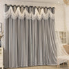 Gray sheer curtains with white lace trim and wave pattern hanging in a window.