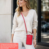 A woman models a red compact PU leather crossbody bag and strap with light-colored pants.
