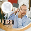 A woman uses reusable silicone suction phone mounts for a selfie in a mirror.