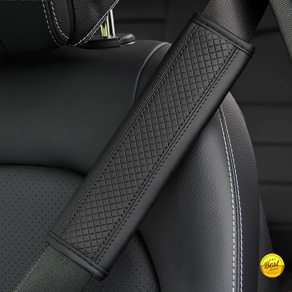 A close-up of a black PU leather embossed seat belt shoulder cushion on a vehicle seat.