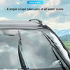 A close-up view of a car windshield with water stains, showing a wiper blade and a cleaning product.