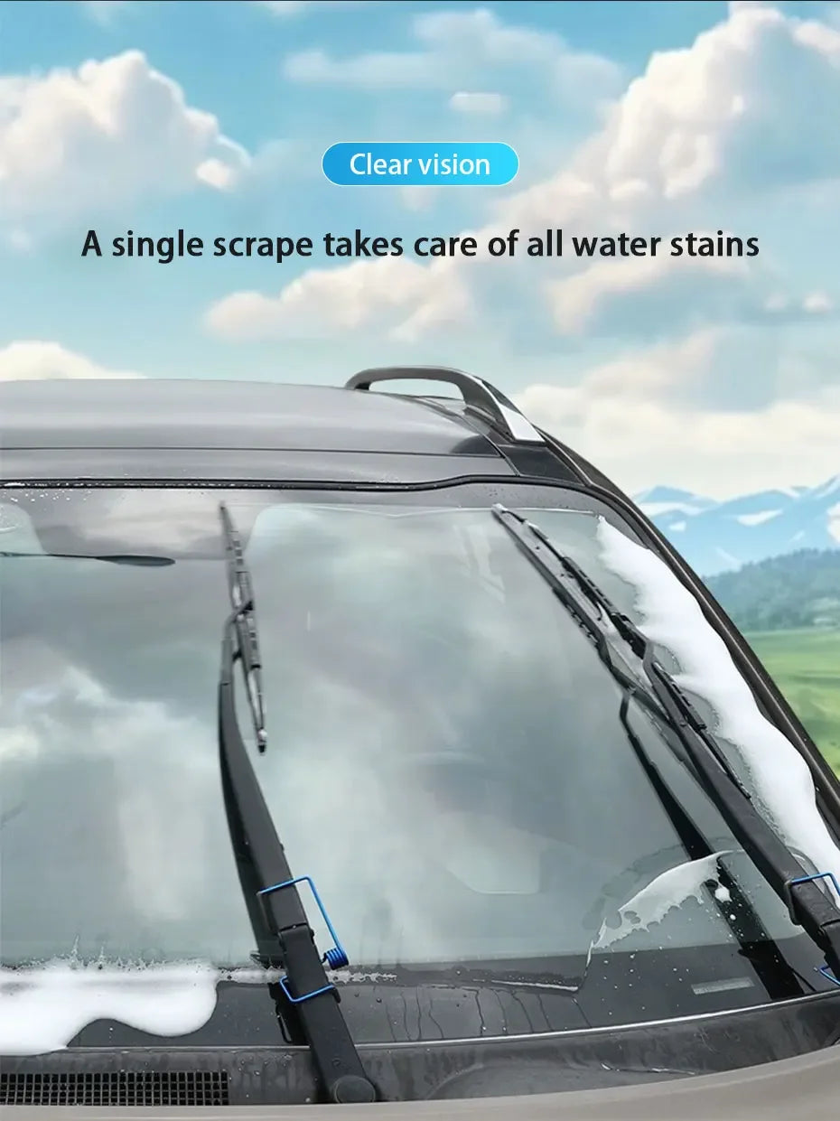 A close-up view of a car windshield with water stains, showing a wiper blade and a cleaning product.
