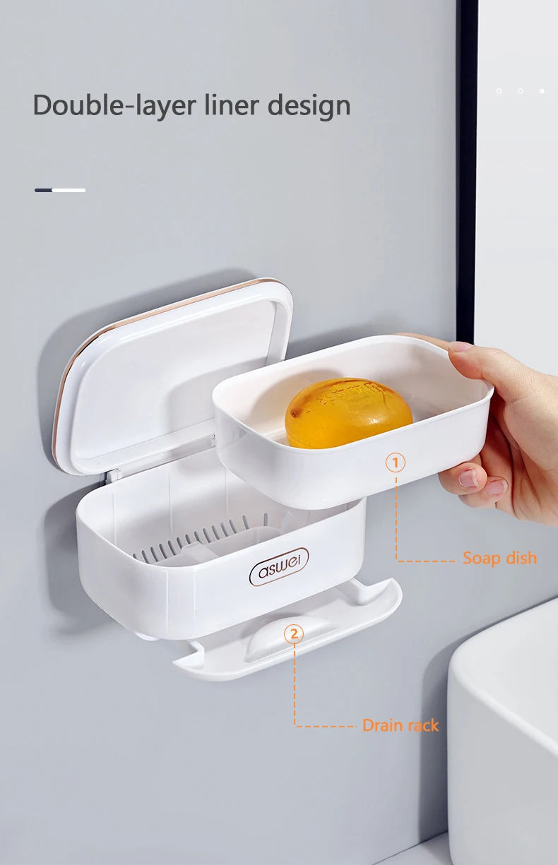A white double-layer liner design soap dish with a drain rack mounted on a wall for bathroom use.