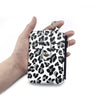 A hand holds a leopard print PU leather card holder with a coin pocket and keychain.