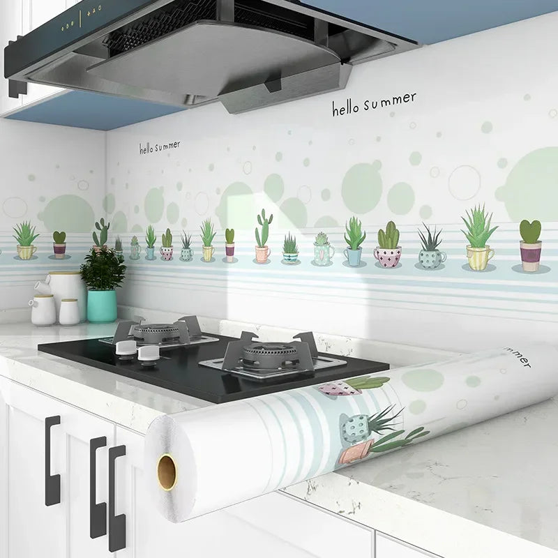 A white kitchen splashback featuring green succulent stickers and a stainless steel hood.
