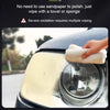 A hand wipes a headlight lens with a white towel to restore clarity and remove oxidation.