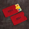 Two red RFID protection cards and one yellow UnionPay card are displayed on a dark surface.