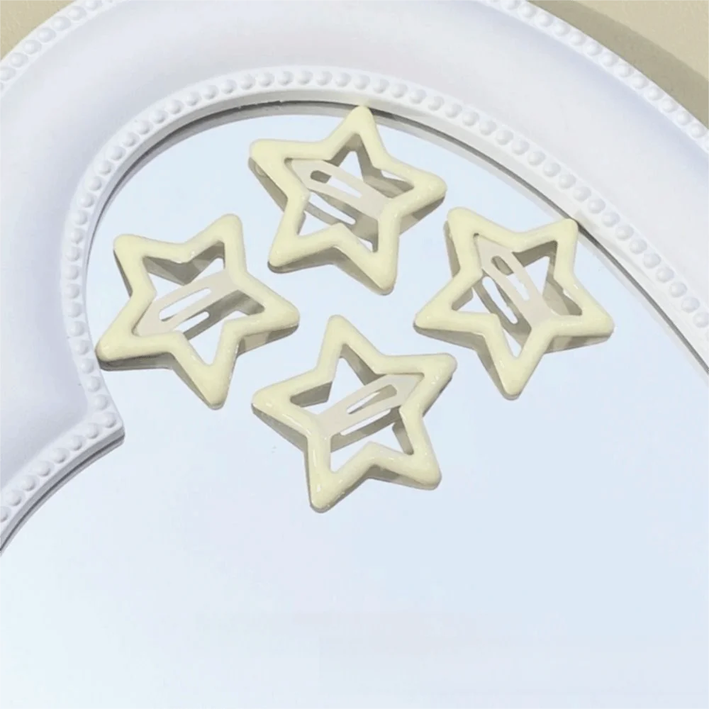 A set of ten white star-shaped hair clips is displayed on a white background.