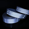 Rolls of high-visibility reflective safety tape for vehicles displayed against a dark background.