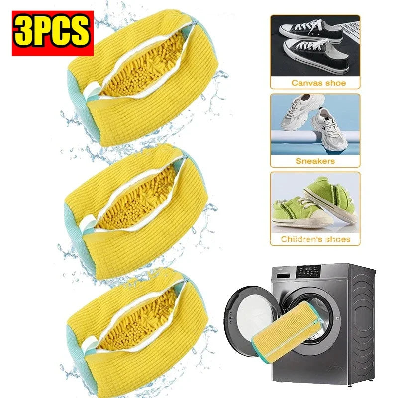 Three yellow reusable shoe laundry bags with bristled brushes shown next to a washing machine.