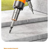 Close-up of an orange and black precision rechargeable electric screwdriver with a metallic tip resting on a gray surface.