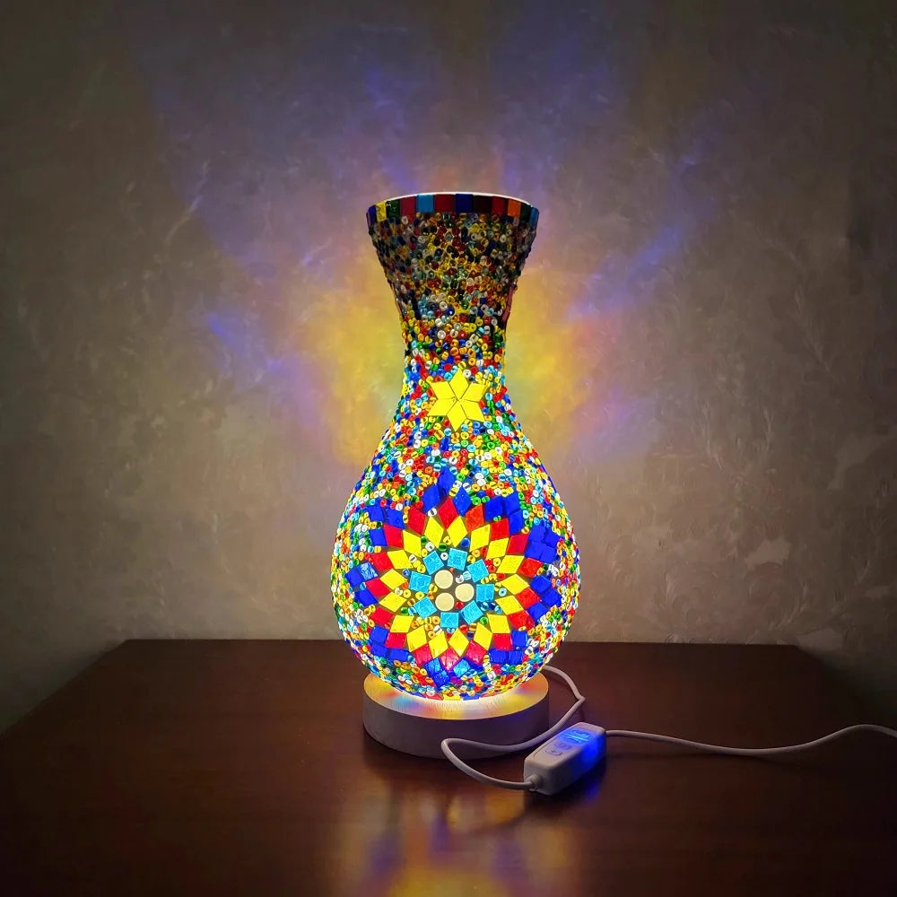 A handcrafted Turkish mosaic table lamp with a vibrant, colorful glass base and warm LED glow.