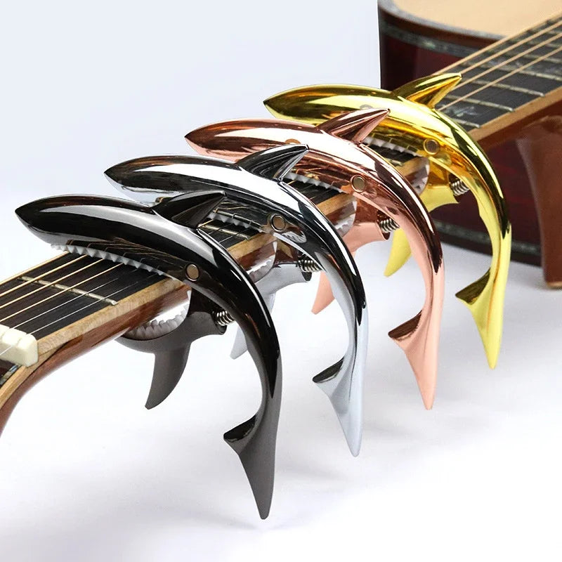 A set of five shark-design guitar caps with zinc alloy build in various colors including black, silver, rose gold, and gold.