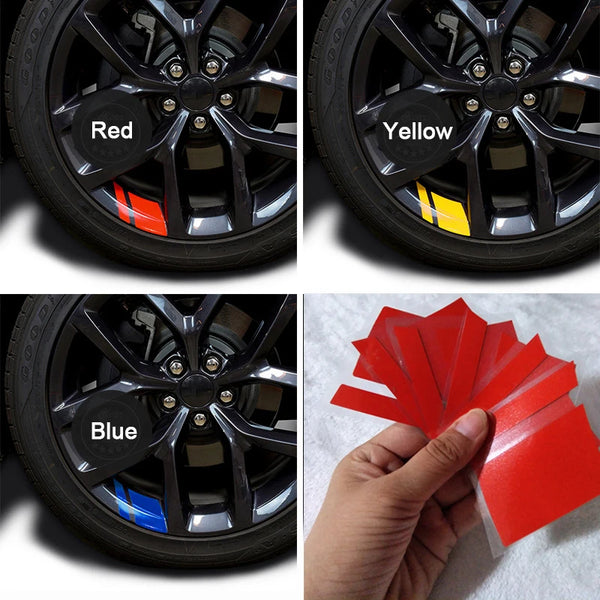 Three car wheel rims showing red, yellow, and blue reflective decals.