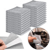 A stack of gray triple-layer microfiber scouring cloths and a single cloth are shown next to a kitchen appliance.