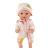 A baby doll wearing a pink jumpsuit outfit with a green map design on the hood