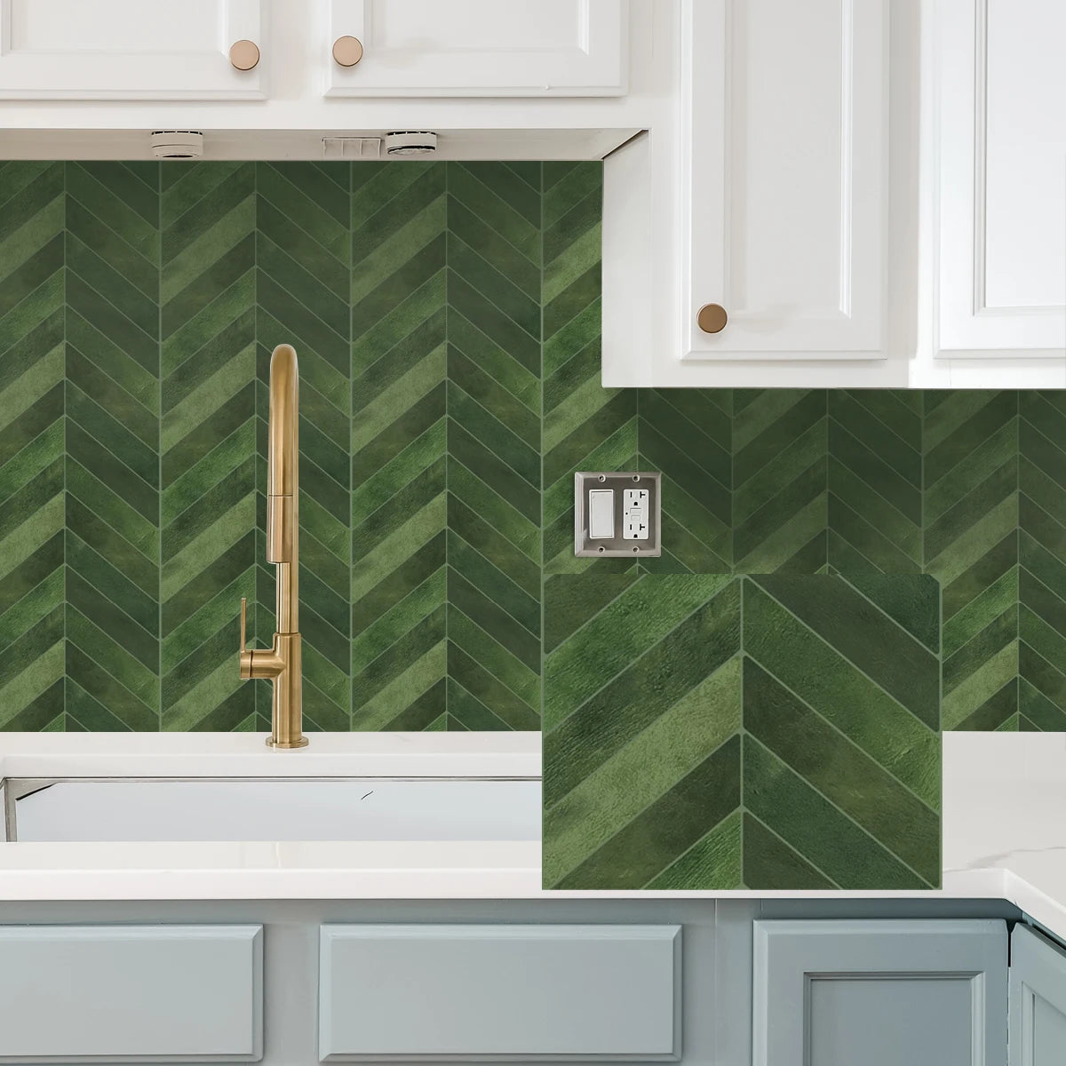 A kitchen backsplash featuring a green diagonal tile pattern under white cabinets and a light countertop.