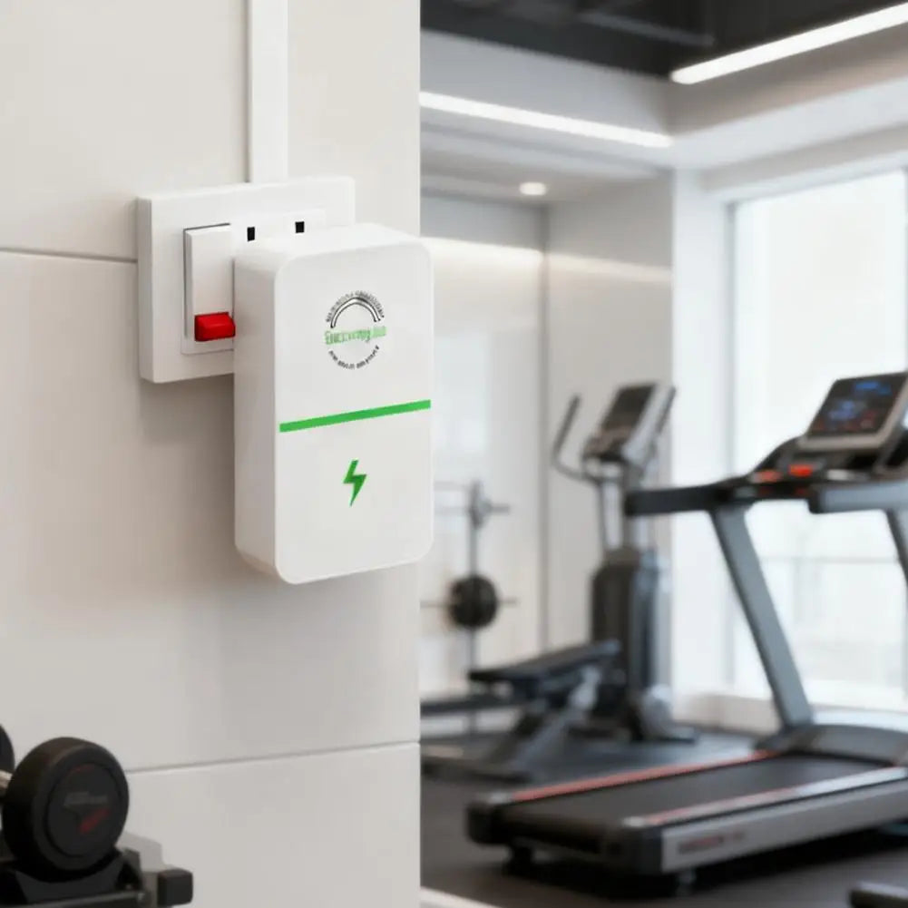 A white energy saver plug with a green lightning bolt is mounted on a white wall in a modern gym setting.