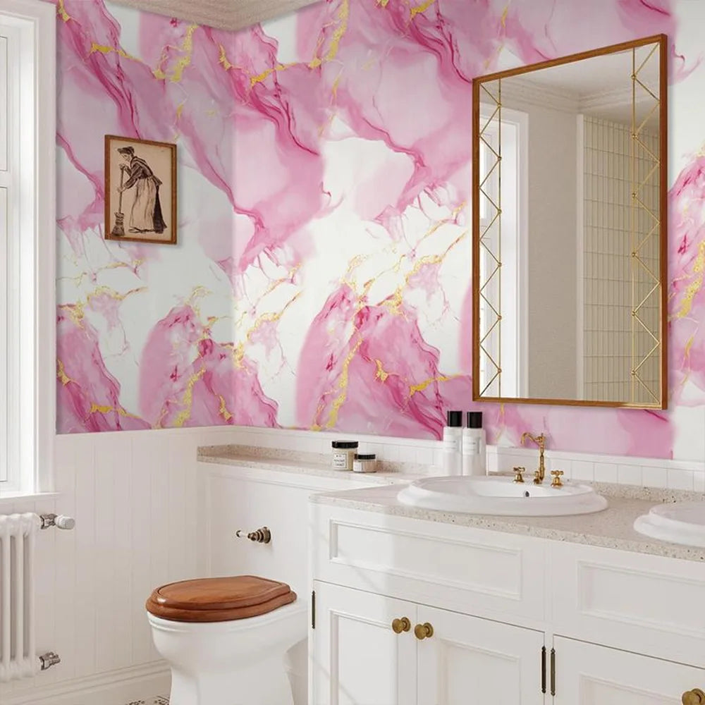 Pink and gold marble pattern self-adhesive wallpaper on a wall above a white vanity and toilet.