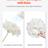 White silk hydrangea flowers shown with a hand adjusting them for a bouquet