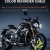 A black motorcycle is shown with a 5ft bright color reminder cable attached to the frame.