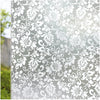 Close-up of frosted stripe privacy window film featuring an ornate white floral scroll pattern.