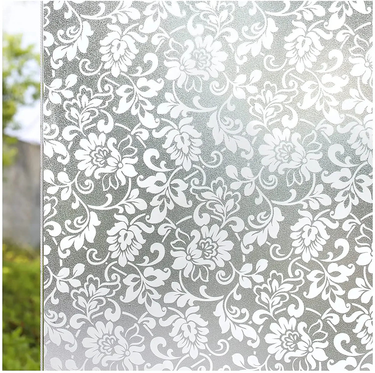 Close-up of frosted stripe privacy window film featuring an ornate white floral scroll pattern.