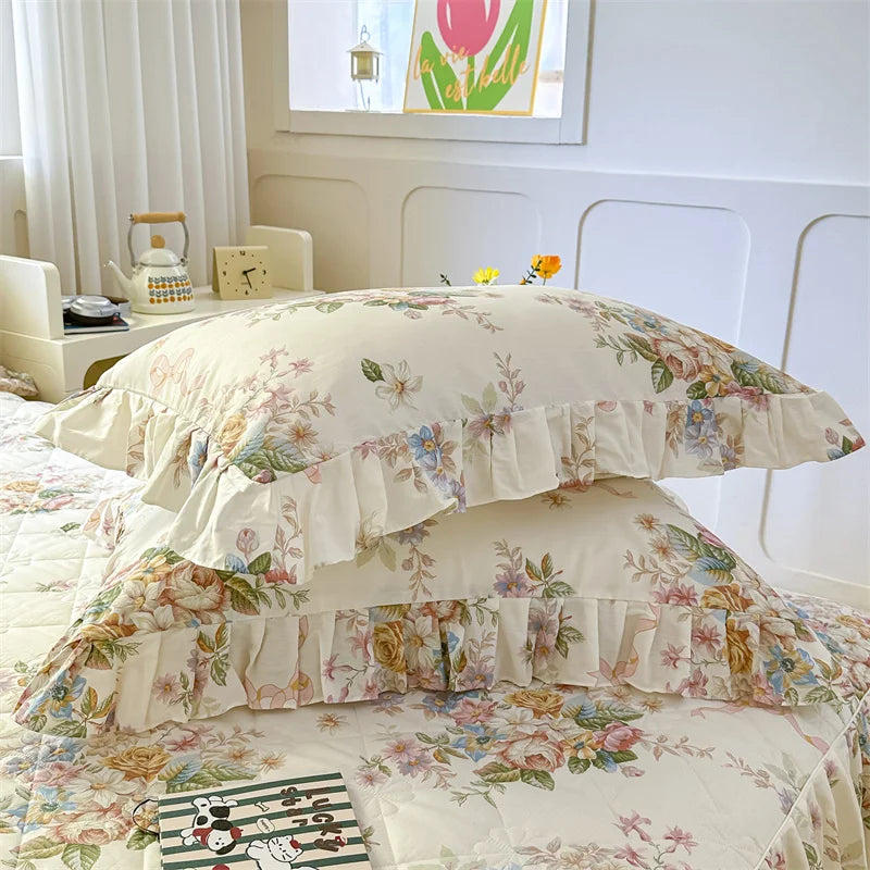 A floral cotton pillowcase set featuring pink and green botanical patterns on a white background.
