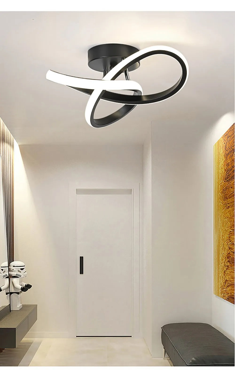 Modern clover LED ceiling light fixture with a black and white ring design mounted on a white wall.