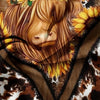 Close-up of a Highland cow print bedding set featuring golden sunflowers and earthy tones.