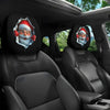 A pair of festive Santa face headrest covers accenting the interior of a car seat.