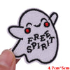 White embroidered patch of a cute ghost face with a happy expression and the text FREE SPIRIT