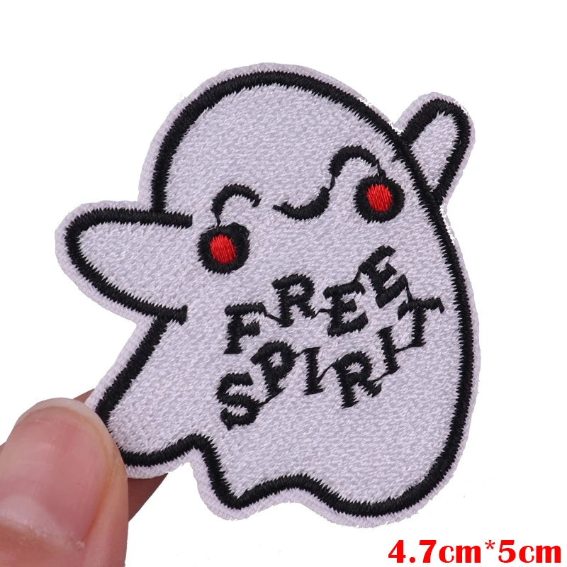 White embroidered patch of a cute ghost face with a happy expression and the text FREE SPIRIT