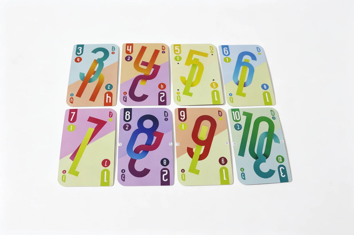 A set of ten numbered cards from an Omega Card Game featuring colorful numbers and symbols.