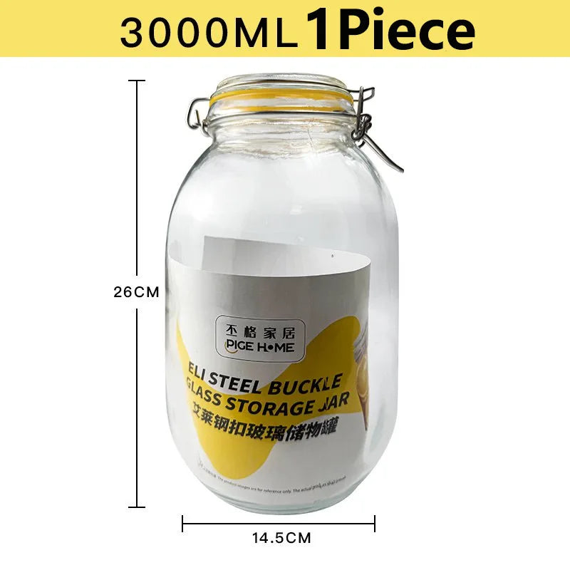 A clear glass storage jar with a metal clamp lid, labeled as an Eli Steel Buckle Glass Storage Jar.